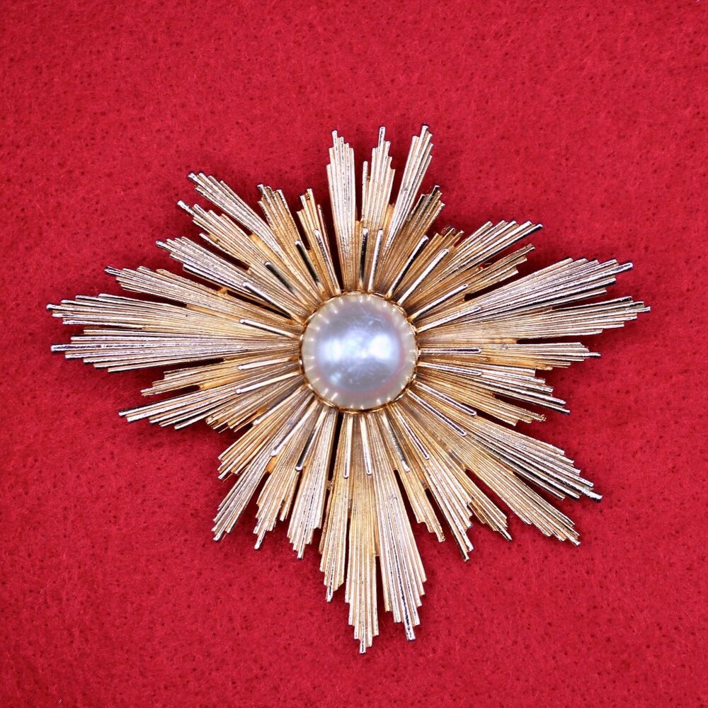 MCM Atomic-Age Starburst Brooch with Pearl Center.